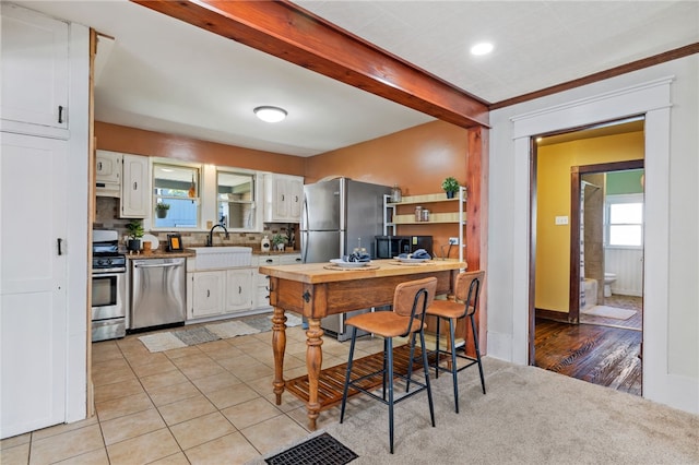 12091/2 Vance Ave, Coraopolis, PA 15108 - kitchen with appliances with stainless steel finishes, white cabinets, backsplash, under cabinet range hood, and recessed lighting