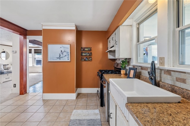 12091/2 Vance Ave, Coraopolis, PA 15108 - kitchen with stainless steel range with gas cooktop, under cabinet range hood, white cabinetry, and healthy amount of natural light
