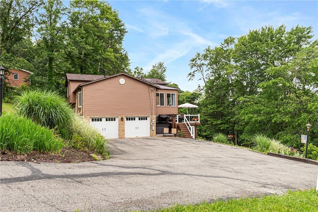223 Horseshoe Dr, Adams Twp, PA 16046 - view of side of property with stairway, asphalt driveway, a garage, and a deck