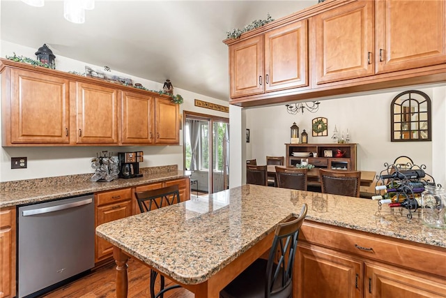 223 Horseshoe Dr, Adams Twp, PA 16046 - kitchen featuring dishwasher, wood finished floors, brown cabinets, and light stone counters