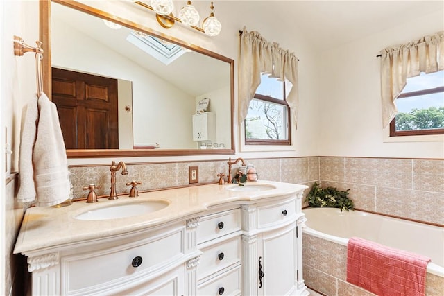 223 Horseshoe Dr, Adams Twp, PA 16046 - full bathroom featuring a skylight, double vanity, lofted ceiling, and a bath