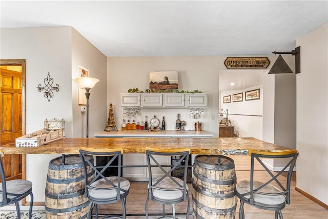 223 Horseshoe Dr, Adams Twp, PA 16046 - indoor wet bar with light wood-style flooring and baseboards