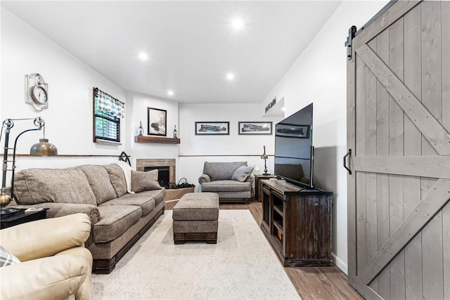 223 Horseshoe Dr, Adams Twp, PA 16046 - living area with a barn door, wood finished floors, recessed lighting, and a fireplace