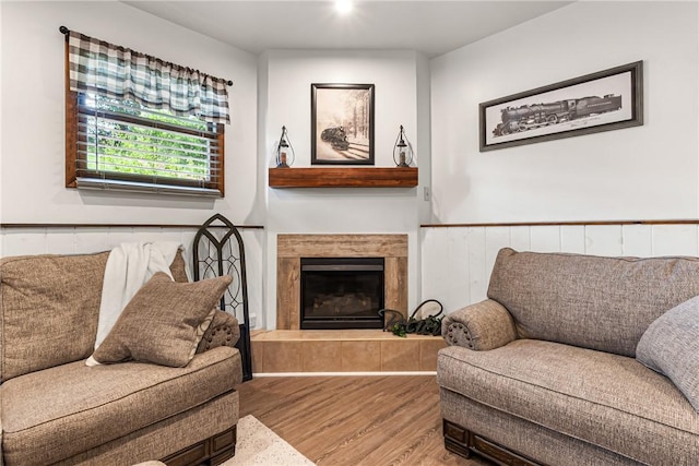 223 Horseshoe Dr, Adams Twp, PA 16046 - living room with wood finished floors, a fireplace with raised hearth, and wainscoting