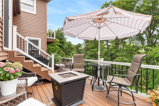 223 Horseshoe Dr, Adams Twp, PA 16046 - deck with a fire pit, stairway, and view of wooded area