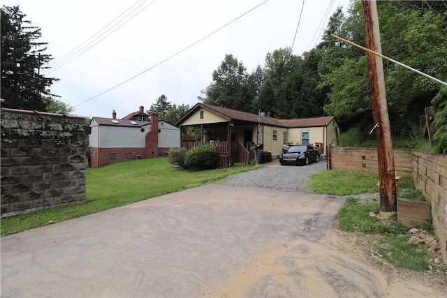 1700 Grall Ave, Shaler, PA 15209 - view of front of house featuring covered porch, driveway, and a front yard