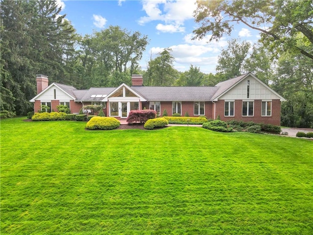 241 W Chapel Ridge Rd, Fox Chapel, PA 15238 - view of front of home with a chimney, brick siding, and a front lawn