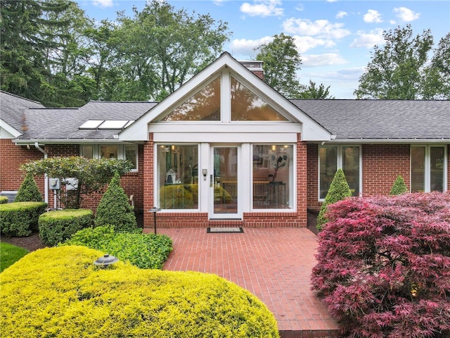 241 W Chapel Ridge Rd, Fox Chapel, PA 15238 - property entrance featuring brick siding, a shingled roof, and a patio