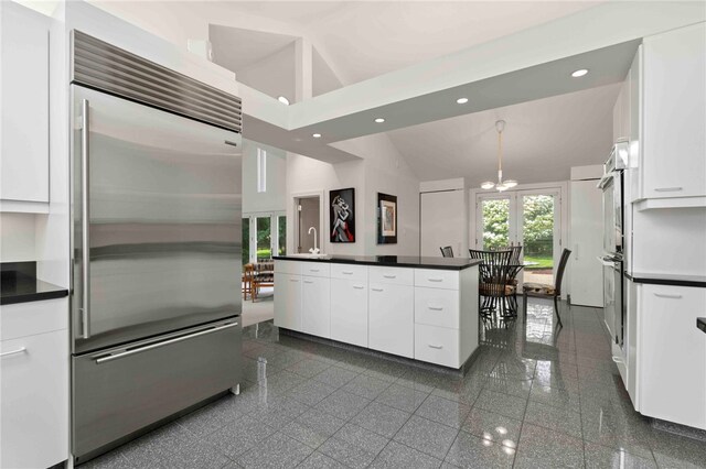 241 W Chapel Ridge Rd, Fox Chapel, PA 15238 - kitchen featuring stainless steel built in refrigerator, white cabinets, dark countertops, granite tiled floors, and recessed lighting