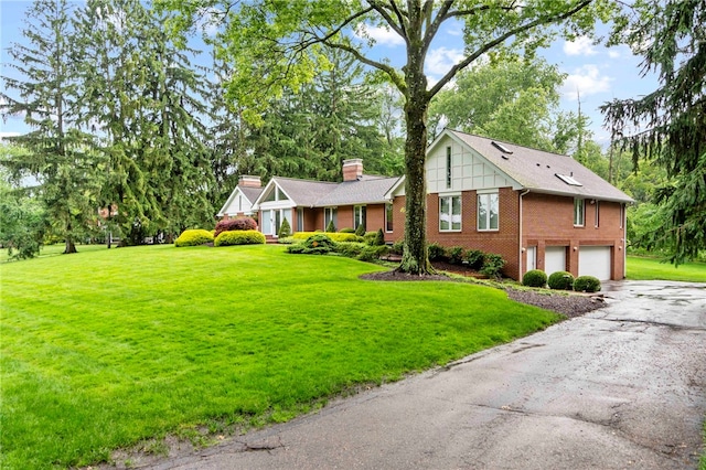 241 W Chapel Ridge Rd, Fox Chapel, PA 15238 - view of front of house with brick siding, a garage, a chimney, driveway, and a front lawn