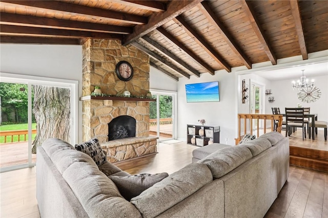 2805 Hamilton Ave, Shaler, PA 15116 - living room with a chandelier, wood ceiling, wood finished floors, and a stone fireplace