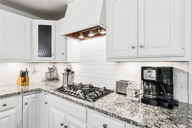 2805 Hamilton Ave, Shaler, PA 15116 - kitchen with custom range hood, gas cooktop, white cabinetry, and decorative backsplash