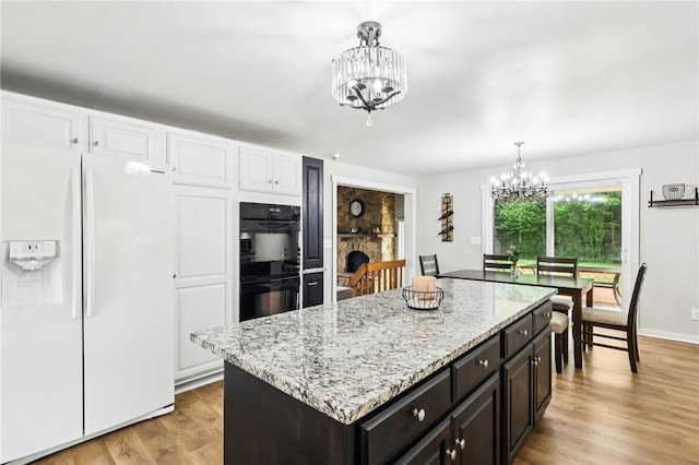 2805 Hamilton Ave, Shaler, PA 15116 - kitchen featuring white refrigerator with ice dispenser, a chandelier, pendant lighting, light stone counters, and light wood-type flooring
