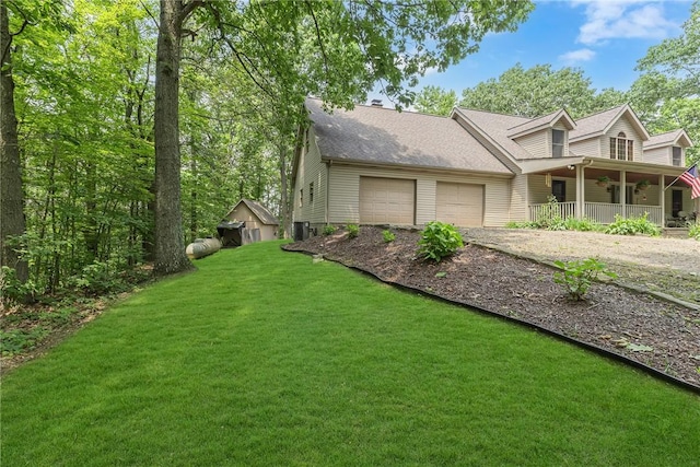 3824 Ridge Rd, Independence Bea, PA 15001 - view of property exterior featuring a porch, a lawn, driveway, a garage, and a shingled roof