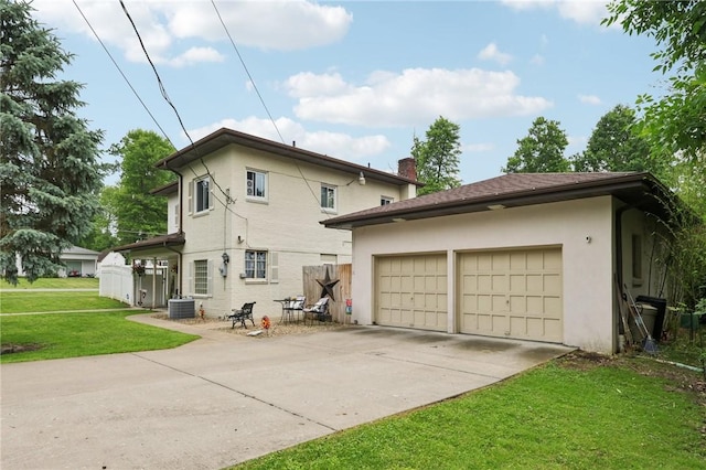 6 Edgewood Acres, Neshannock Twp, PA 16105 - back of house featuring driveway, a lawn, a garage, and stucco siding