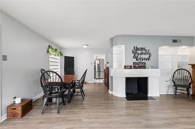 6 Edgewood Acres, Neshannock Twp, PA 16105 - dining space with wood finished floors and a fireplace with flush hearth