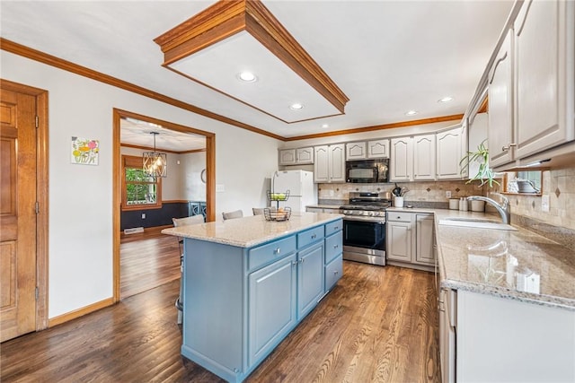 1007 Braemar Dr, Penn Twp Wml, PA 15644 - kitchen featuring stainless steel range with gas stovetop, black microwave, freestanding refrigerator, ornamental molding, and dark wood-style floors