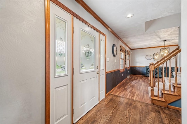 1007 Braemar Dr, Penn Twp Wml, PA 15644 - foyer entrance featuring dark wood-type flooring, wainscoting, a chandelier, stairs, and crown molding