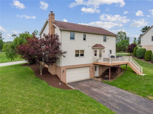 1007 Braemar Dr, Penn Twp Wml, PA 15644 - back of house featuring a chimney, a garage, asphalt driveway, a lawn, and a wooden deck
