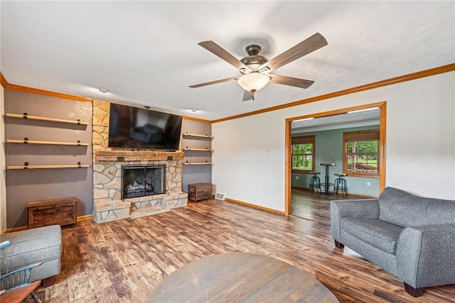 1007 Braemar Dr, Penn Twp Wml, PA 15644 - living room with crown molding, wood finished floors, ceiling fan, and a stone fireplace