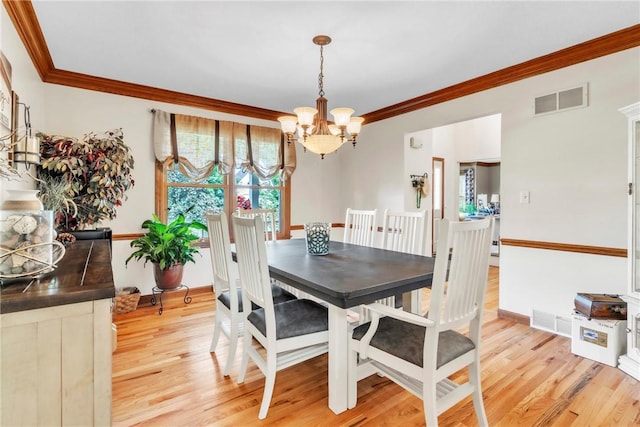 139 Village Dr, Cranberry Twp, PA 16066 - dining space with a chandelier, ornamental molding, and light wood-style flooring