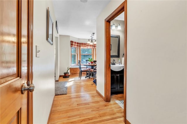 139 Village Dr, Cranberry Twp, PA 16066 - corridor featuring light wood-style flooring and a chandelier