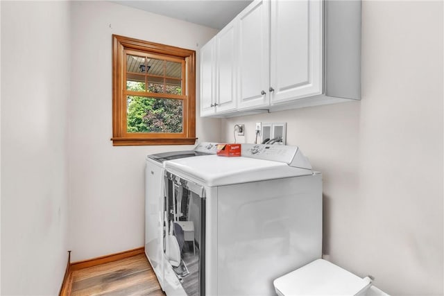 139 Village Dr, Cranberry Twp, PA 16066 - washroom featuring washing machine and clothes dryer, cabinet space, and light wood finished floors