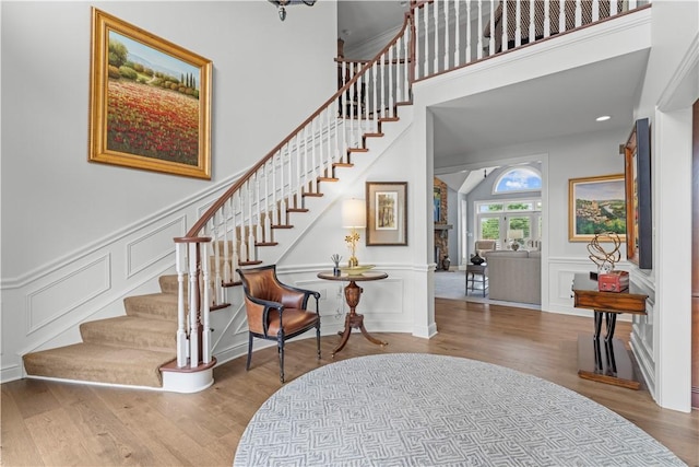 1055 Saint Mellion Dr, Collier Twp, PA 15142 - staircase with a decorative wall, wood finished floors, and wainscoting
