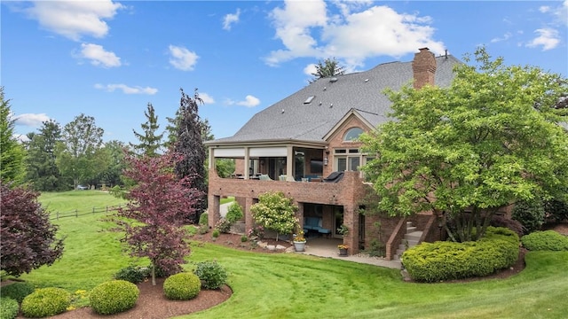 1055 Saint Mellion Dr, Collier Twp, PA 15142 - back of house featuring brick siding, a patio area, a chimney, and a sunroom