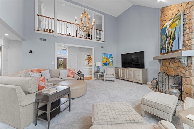 1055 Saint Mellion Dr, Collier Twp, PA 15142 - carpeted living room featuring high vaulted ceiling, a chandelier, and a stone fireplace