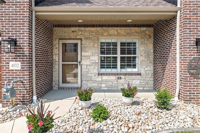 402 Chambers Dr, Canton Twp, PA 15301 - property entrance featuring a shingled roof, brick siding, and stone siding
