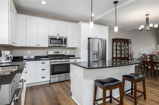 402 Chambers Dr, Canton Twp, PA 15301 - kitchen featuring stainless steel appliances, dark wood-style floors, white cabinetry, a breakfast bar, and recessed lighting