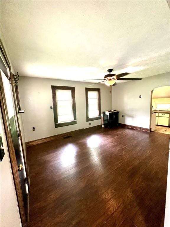43 N 10th St, Sharpsville, PA 16150 - unfurnished living room featuring arched walkways, wood finished floors, and a ceiling fan