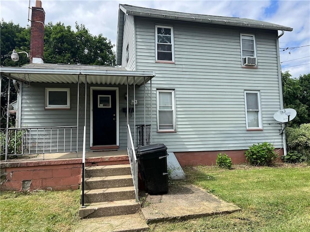 43 N 10th St, Sharpsville, PA 16150 - view of front of property featuring a front yard, cooling unit, covered porch, and a chimney