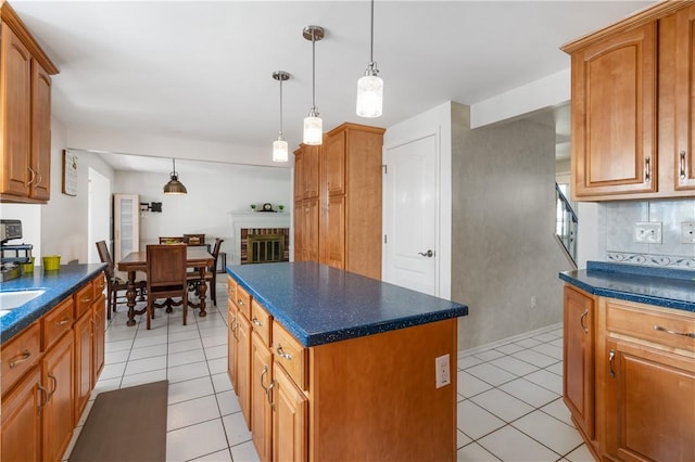 126 Penn Lear Dr, Monroeville, PA 15146 - kitchen with light tile patterned flooring, dark countertops, a center island, and hanging light fixtures