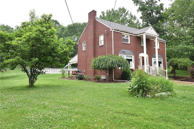 714 Colonial, Coolbaugh Twp, PA 15613 - view of property exterior with a chimney, a lawn, and brick siding