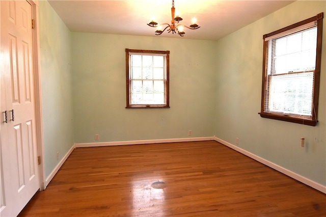 714 Colonial, Coolbaugh Twp, PA 15613 - unfurnished room with a chandelier and wood finished floors
