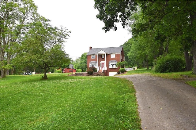 714 Colonial, Coolbaugh Twp, PA 15613 - view of front of home featuring asphalt driveway, a chimney, and a front yard