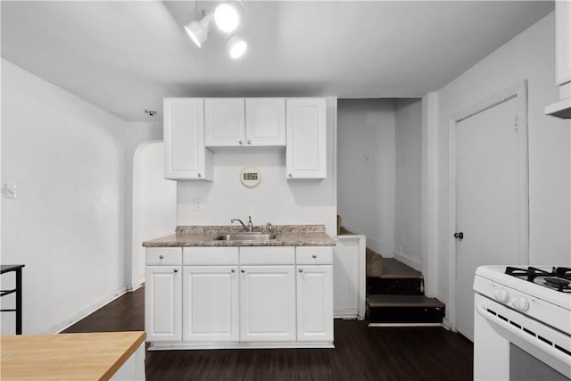 159 S 16th St, South Side, PA 15203 - kitchen featuring dark wood-style floors, white cabinetry, light countertops, white range with gas cooktop, and arched walkways