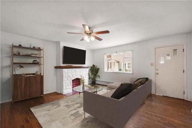 159 S 16th St, South Side, PA 15203 - living room featuring wood finished floors, a ceiling fan, a fireplace, and baseboard heating
