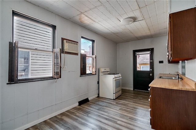 538 Maplewood Ave, Ambridge, PA 15003 - kitchen with white range with gas cooktop, wood finished floors, healthy amount of natural light, and a wall mounted AC