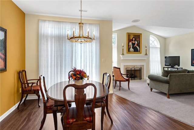 560 Madison Blvd, New Sewickley Twp, PA 15042 - dining room with a chandelier, dark wood-type flooring, a tile fireplace, and lofted ceiling