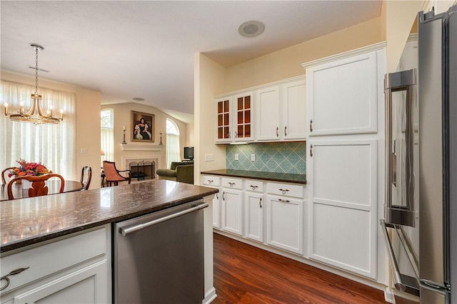 560 Madison Blvd, New Sewickley Twp, PA 15042 - kitchen featuring stainless steel appliances, white cabinets, a fireplace, glass insert cabinets, and decorative backsplash