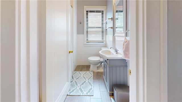 5445 Covode Pl, Squirrel Hill, PA 15217 - bathroom with wood finished floors, vanity, tile walls, and wainscoting