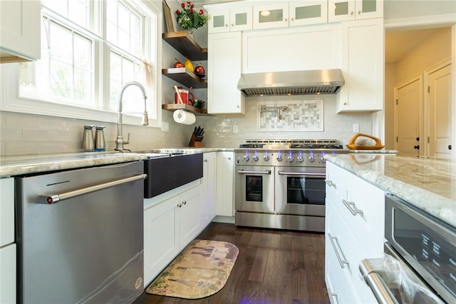 203 Ironwood Ct, Peters Twp, PA 15367 - kitchen featuring stainless steel appliances, wall chimney range hood, white cabinets, backsplash, and dark wood-style flooring