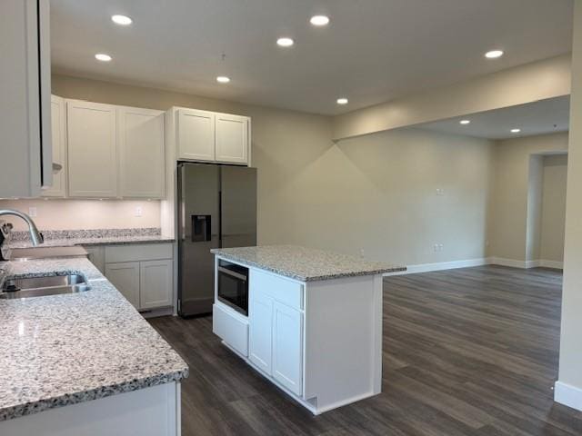 3273 Brodhead Rd Unit D, Center Twp Bea, PA 15001 - kitchen featuring stainless steel refrigerator with ice dispenser, dark wood finished floors, black microwave, a kitchen island, and light stone counters
