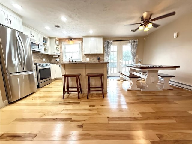 84 Williamson Rd, Hempfield Twp Mer, PA 16125 - kitchen with appliances with stainless steel finishes, light wood-type flooring, healthy amount of natural light, white cabinetry, and recessed lighting