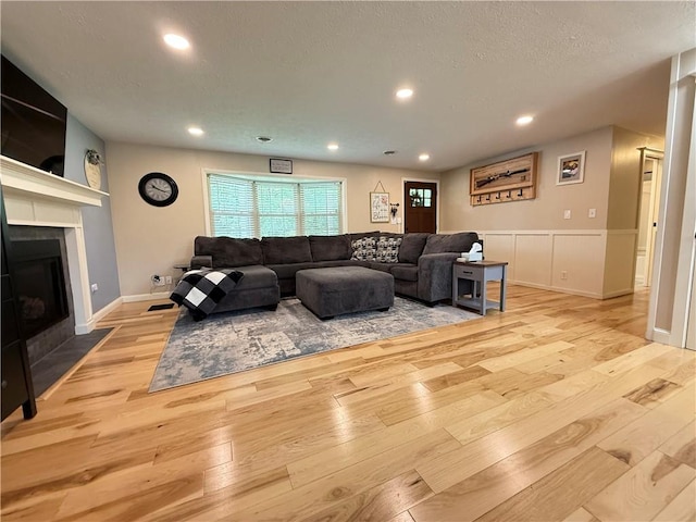 84 Williamson Rd, Hempfield Twp Mer, PA 16125 - living area featuring hardwood / wood-style flooring, a fireplace with flush hearth, a wainscoted wall, recessed lighting, and a textured ceiling