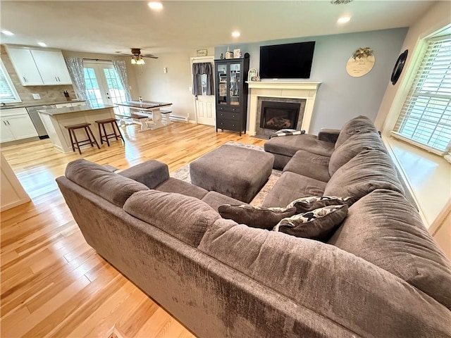 84 Williamson Rd, Hempfield Twp Mer, PA 16125 - living area with light wood-style flooring, ceiling fan, recessed lighting, a fireplace with flush hearth, and french doors