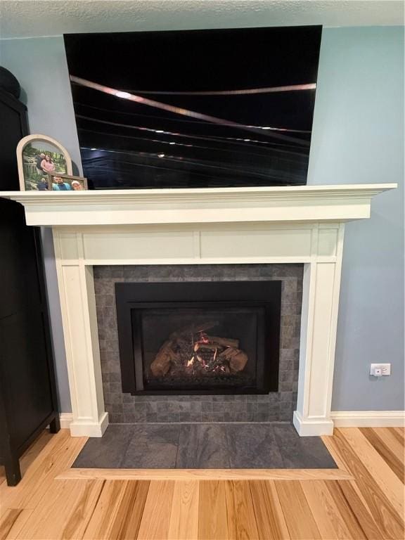 84 Williamson Rd, Hempfield Twp Mer, PA 16125 - detailed view of a tile fireplace and wood finished floors